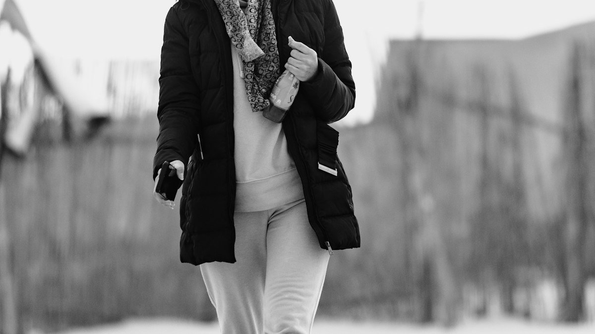 Vitamin D in winter UK: woman walking outdoors in a scarf on a cold day